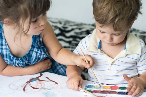 Children playing and painting at home or kindergarten or playschool