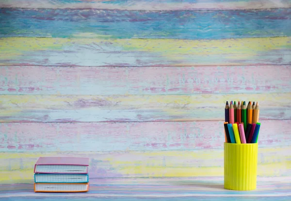 School or student supplies, stationery on colored wooden background - space for caption.