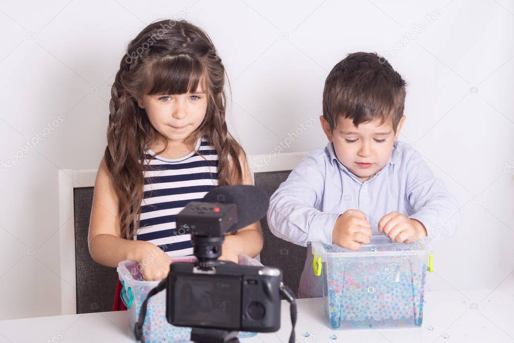 Blogger kid posing in front of camera for recording homemade video to vlog. Children make vlog for social media channel. Blogging, technology and people concept. 