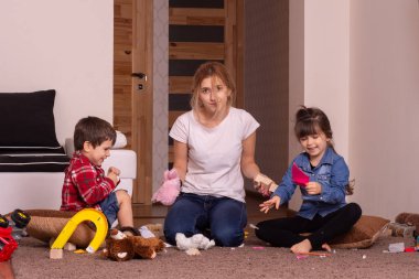 Annem evi toparlamaya yorgun. Çocuk dağınık oyuncaklar. Evde karışıklık var. Kardeş