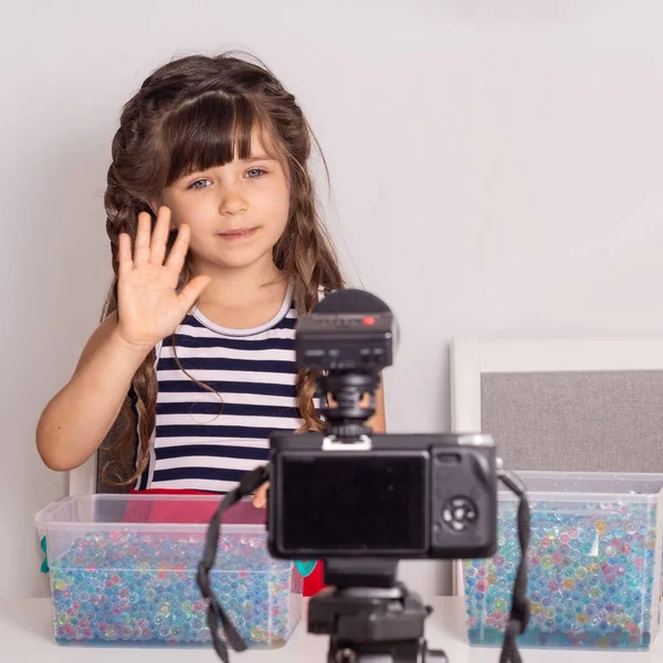 Children vlogger filming she daily video diary outdoors. Kid creating social media content. Girl and boy playing and talking on camera at home, they make video blog.