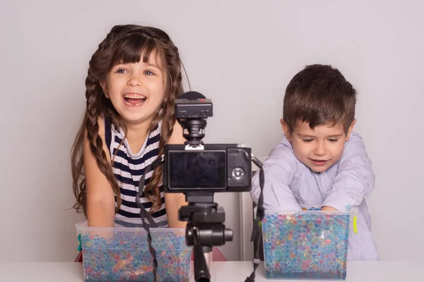 Cute little video bloggers recording video on white background. Kids video blog concept.