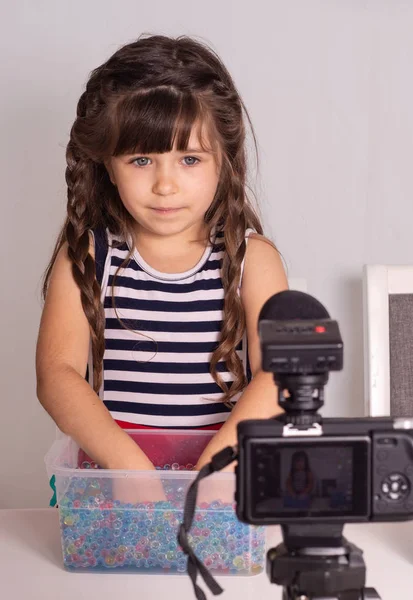 Children vlogger filming she daily video diary outdoors. Kid creating social media content. Girl and boy playing and talking on camera at home, they make video blog.