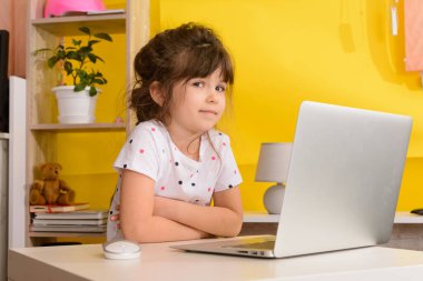 Çocuklar için İngilizce uzaktan öğrenme. Çocuklar için evde eğitim ve uzak mesafe eğitimi. Video öğretmeniyle internetten kız öğrenci çalışması. 