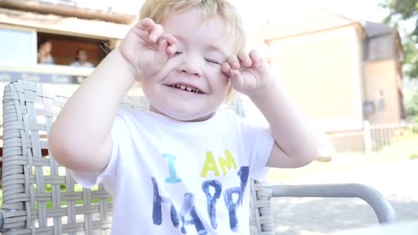 Cute baby playing hide-n-seek and smiling outdoors slowmotion — Stock Video