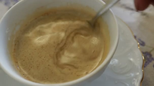 Pouring milk into a cup of coffee — Stock Video