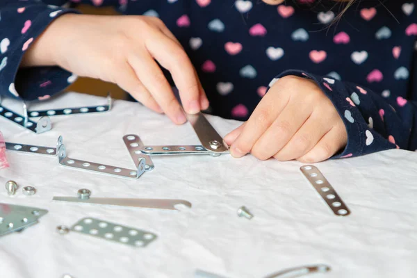 Child plays with iron constructor — Stock Photo, Image