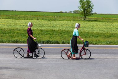 Amish Women Use Bike Scooters clipart