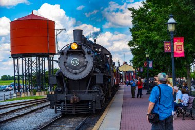 Strasburg, PA / USA - June 27, 2017:  A steam locomotive returns to the station from a passenger excursion in rural Lancaster County, Pennsylvania.