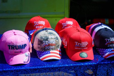 Harrisburg, PA / USA - May 15, 2020: A vendor parked along a street in the downtown part of the city displays Trump 2020 campaign hats for sale during a quarantine protest. clipart