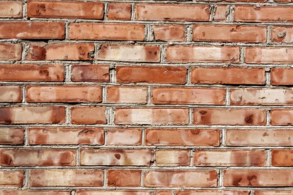 Grungy red brick house wall.