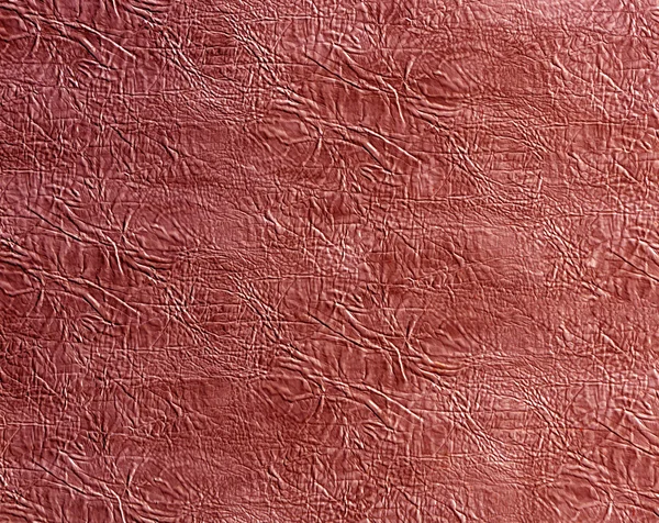 Red artificial leather surface.