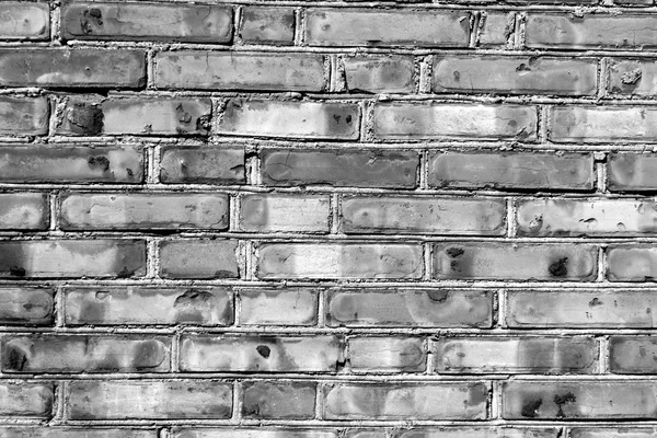 Grungy black and white brick house wall. — Stock Photo, Image