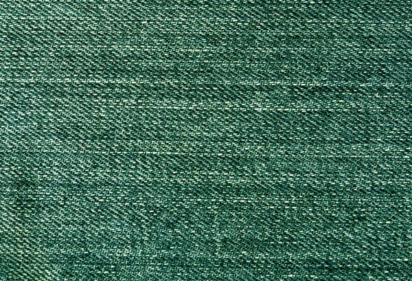 Green jeans textile surface.