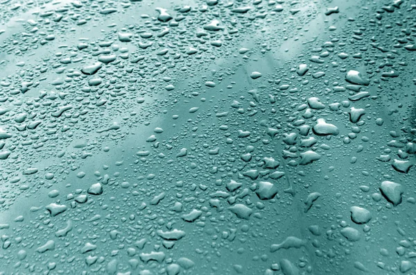 Rain drops on cyan color metal surface. — Stock Photo, Image