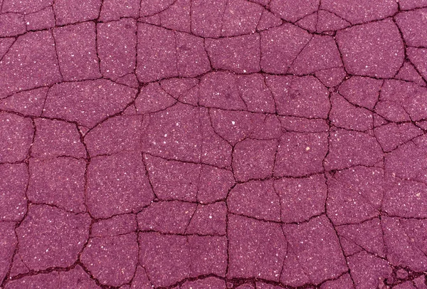 pink toned damaged asphalt texture.