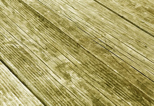 Superfície amarela de madeira com arranhões e efeito borrão — Fotografia de Stock