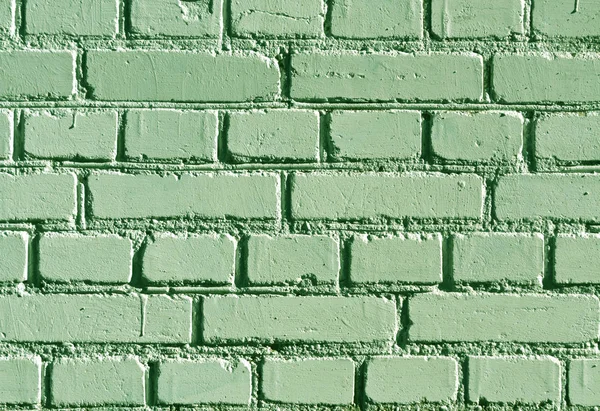 Weathered green color brick wall pattern.