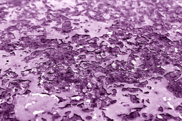 Purple toned rusty metal surface with blur effect.