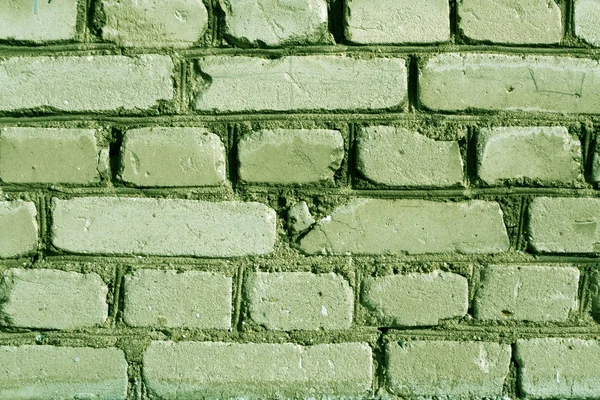 Green weathered brick wall texture.