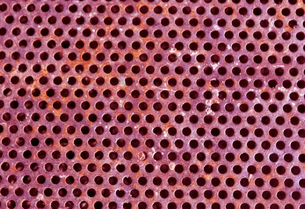 ピンク色の穴があいた金属床パターン. — ストック写真
