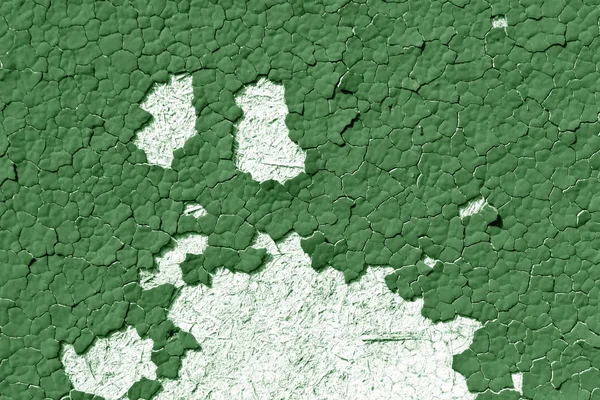 Green color cracked painted wall pattern.