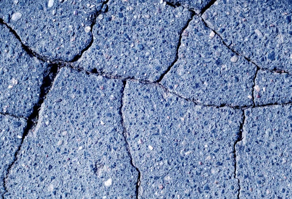 Damaged blue toned asphalt texture