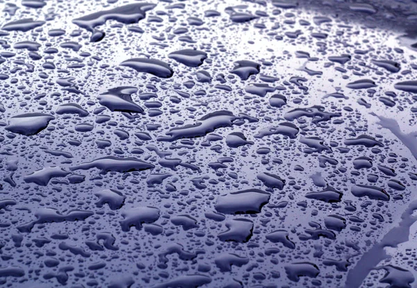 Gotas de água na superfície de metal de cor azul com efeito de borrão — Fotografia de Stock