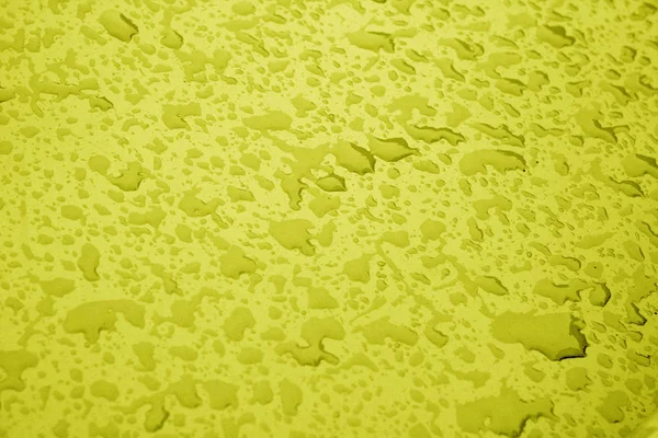 Sarı renkli metal yüzeyinde su damlaları. — Stok fotoğraf