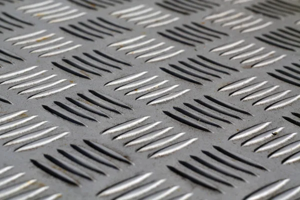 Diamond shaped metal floor pattern with blur effect.