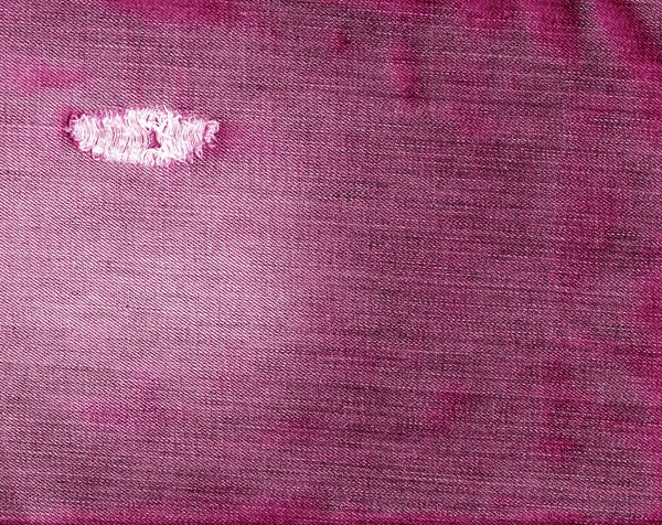 Kolor różowy, podarte dżinsy tekstura tkanina. — Zdjęcie stockowe