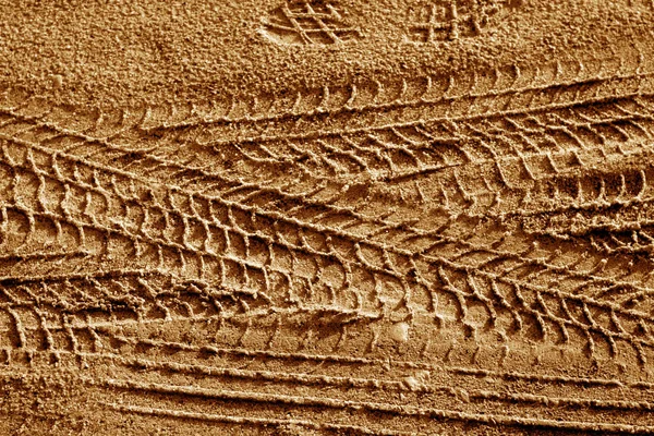 Κομμάτια ελαστικού στην άμμο σε καφέ τόνο. — Φωτογραφία Αρχείου