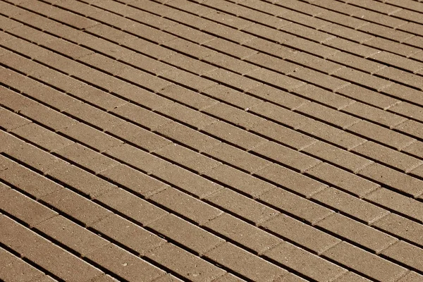 Pietra di ciottolo pavimentazione modello di superficie in tono marrone . — Foto Stock