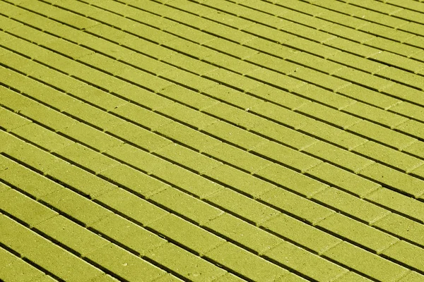 Kopfsteinpflaster Oberfläche Muster in gelbem Ton. — Stockfoto