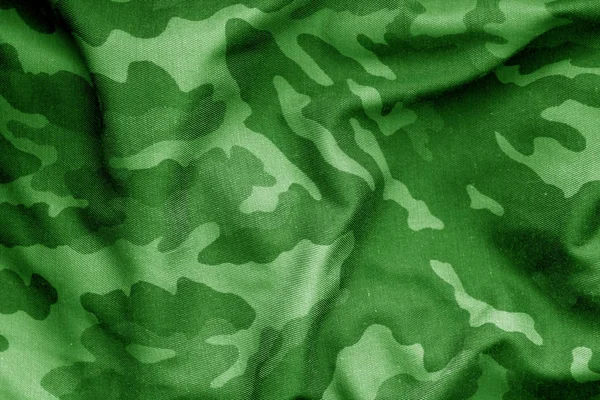 Military uniform pattern with blur effect in green tone.