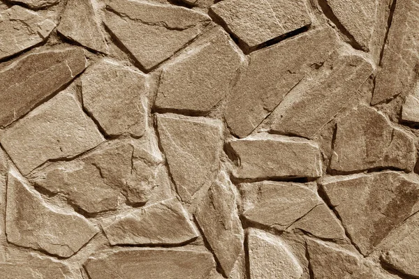 Muur gemaakt van oude stenen in bruine kleur. — Stockfoto
