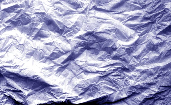 Crumpled sheet of paper with blur effect in blue tone. — Stock Photo, Image