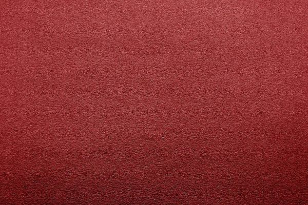 Kunststof glinsterende textuur met wazig effect in rode kleur. — Stockfoto