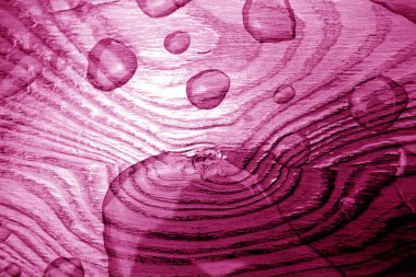 Water drop on wooden surface in pink tone. clipart