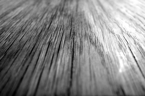 Wooden board texture with blur effect in black and white.