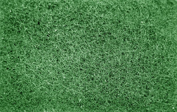 Gąbka czyszcząca pocieranie powierzchni zbliżyć z efektem rozmycia w gre — Zdjęcie stockowe