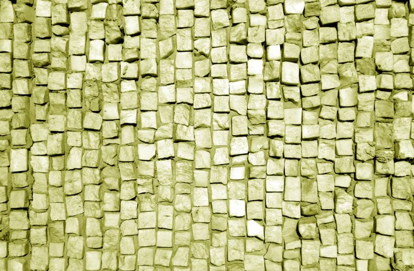 Sarı tonda taş kaldırım yüzeyi.