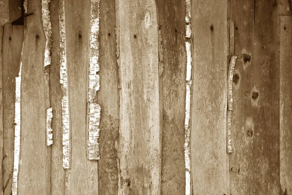 Wall made of uncutted weathered wood boards in brown tone. Royalty Free Stock Photos