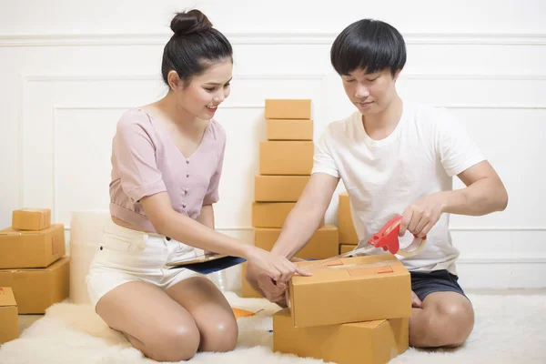 People are preparing products with cardboard boxes for shipping
