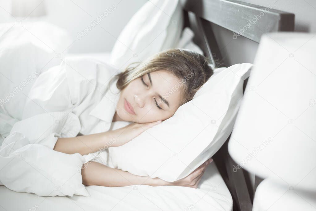 Beautiful woman sleeping on bed 