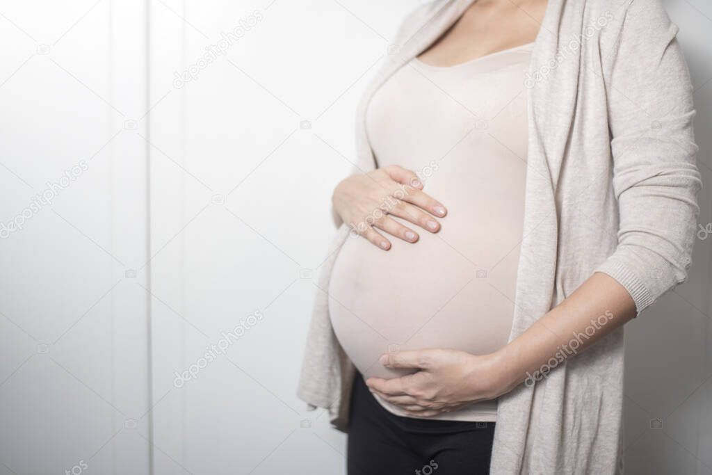 Close up pregnant woman expecting a baby