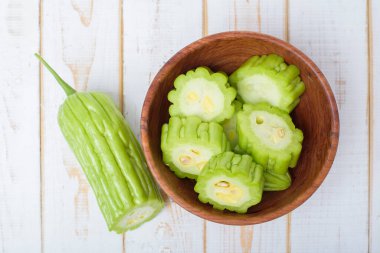 Beyaz ahşap masada acı kavun 