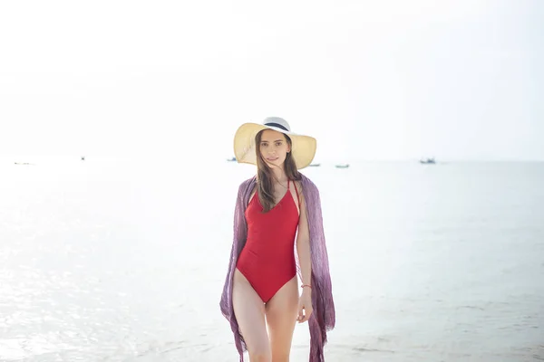 赤い水着の美しい女性が海から歩いている 夏のコンセプト — ストック写真