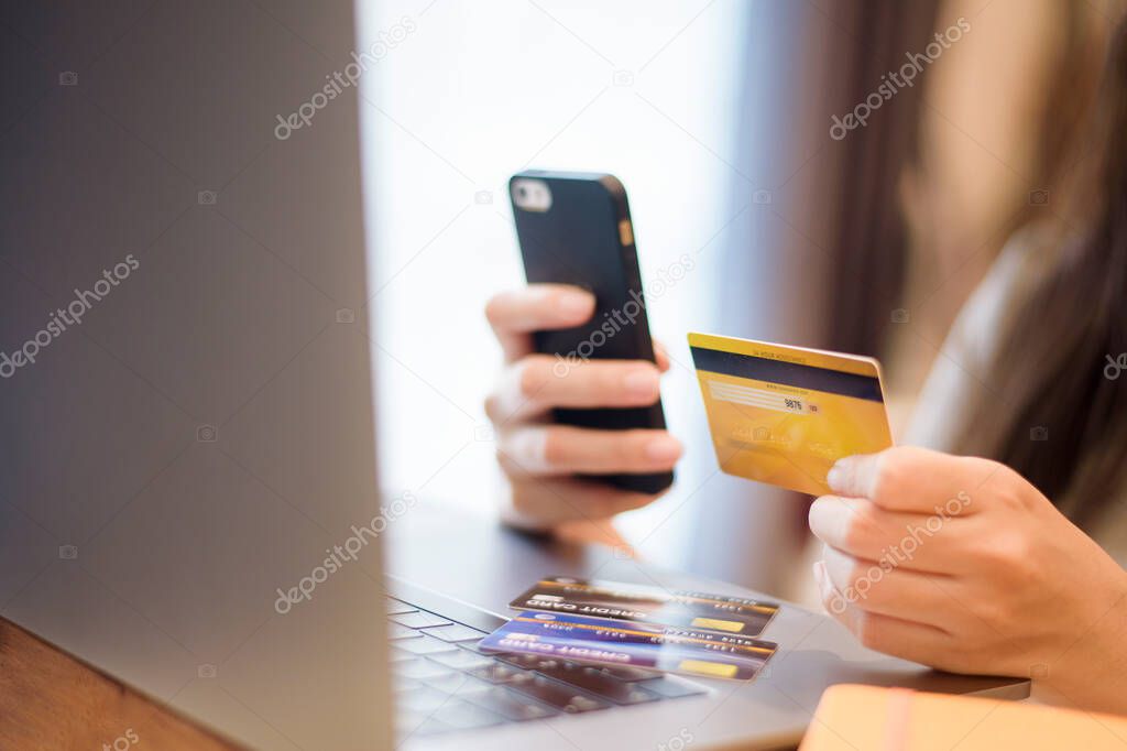 Woman hand is holding credit card, shopping online 