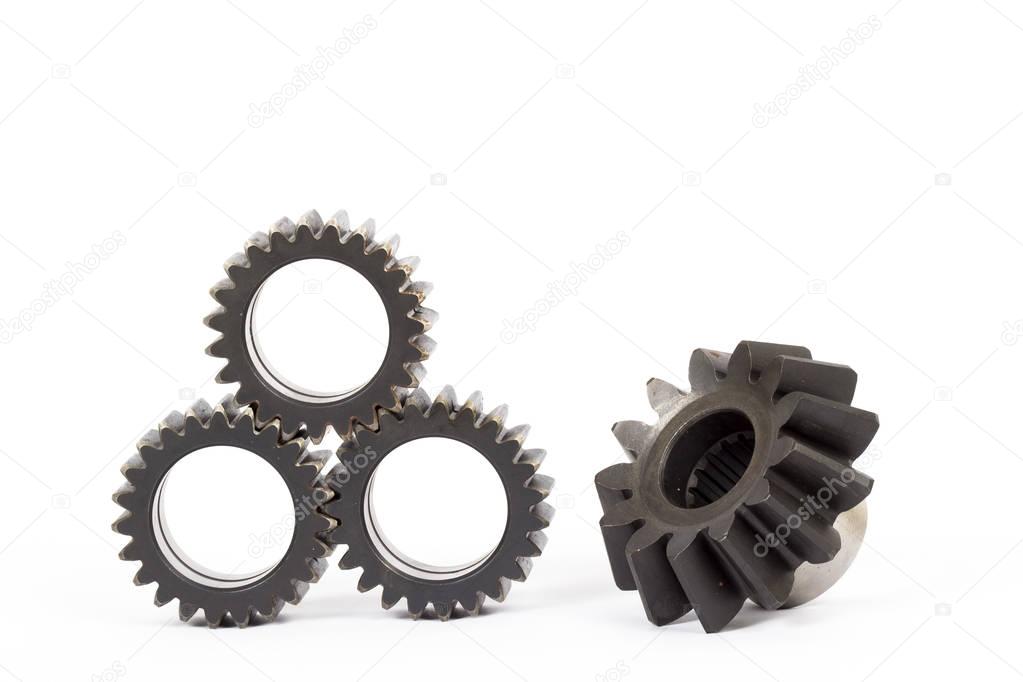 Small group of gears with their teeth engaged on a white background.